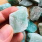 Grade a amazonite raw held in hand for size reference