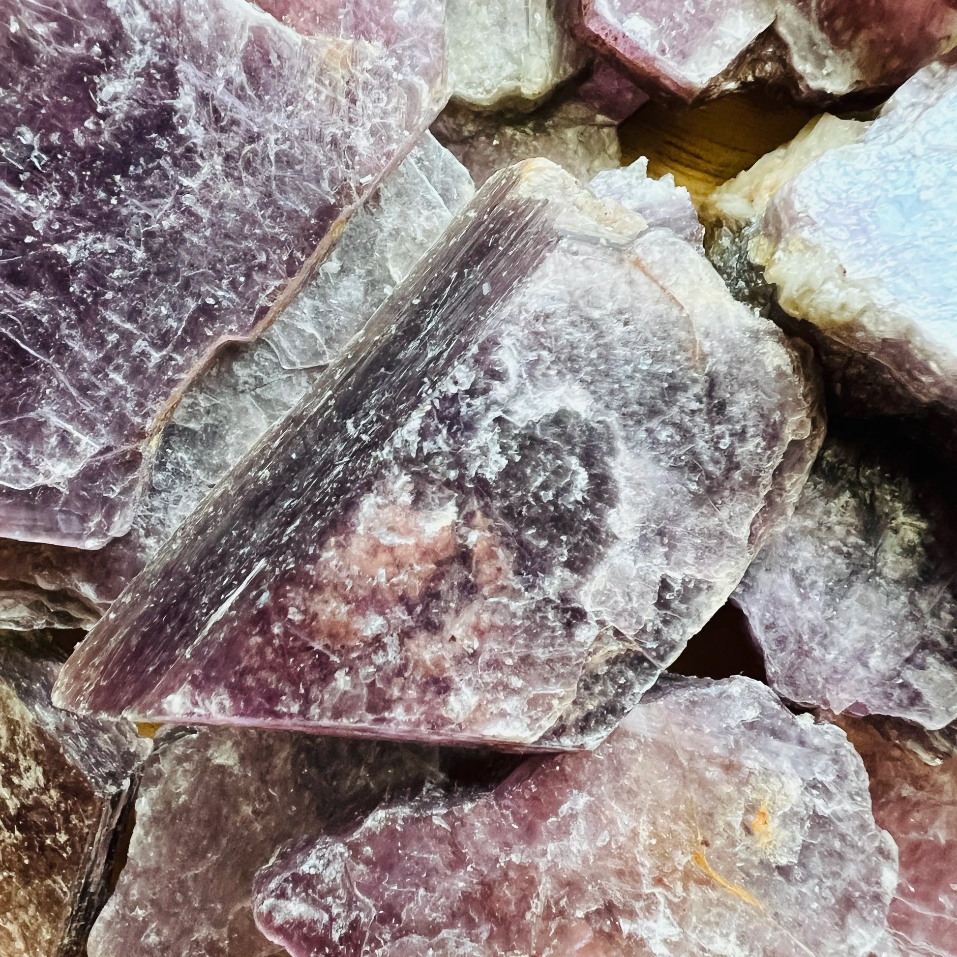 Lateral view of Lepidolite raw stone, drawn on for Stress Relief.