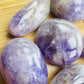 Bottom side of Banded Amethyst palm stone, showing translucent edges, kept near for Stress Relief and Sleep.