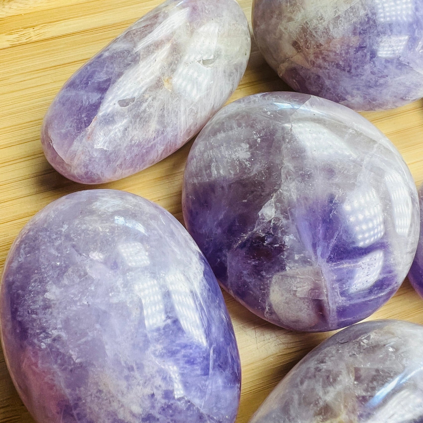Bottom side of Banded Amethyst palm stone, showing translucent edges, kept near for Stress Relief and Sleep.