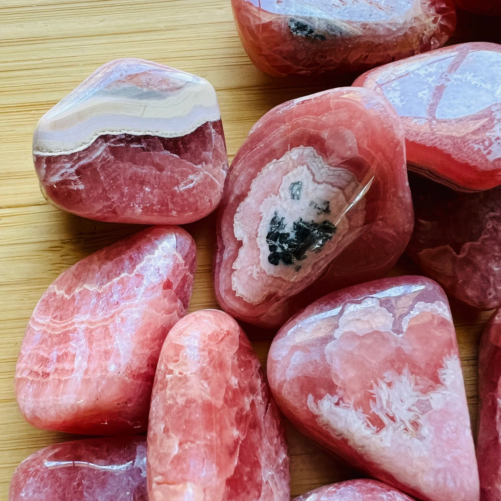 Back view of Rhodochrosite tumbled stone, sourced from Argentina.