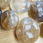 Detail of Natural Citrine palm stone, kept near for Abundance, sourced from Vakinankaratra, Madagascar.