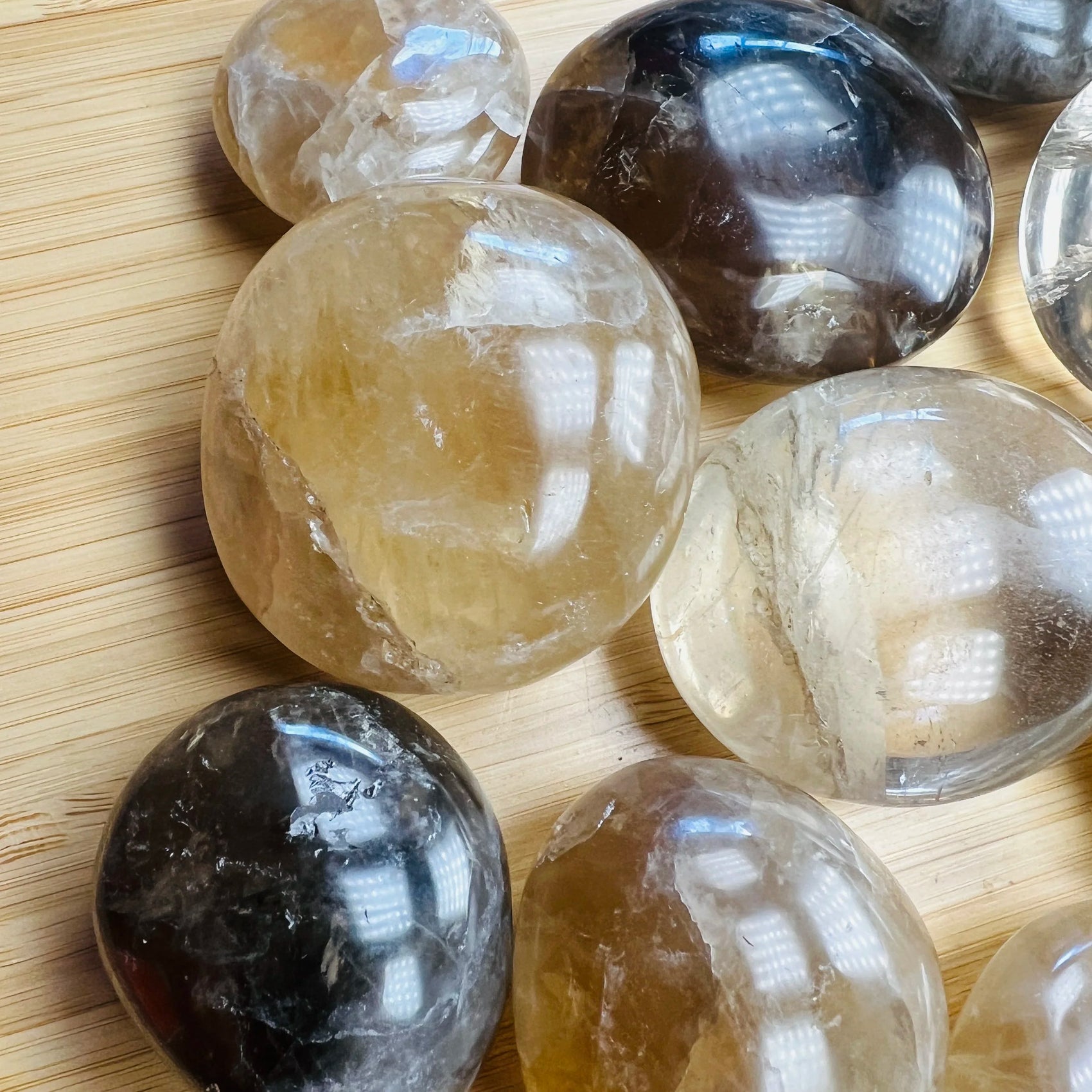 Side profile of Grade A Natural Citrine palm stone, sourced from Madagascar, showing characteristic finish.
