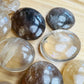 Overhead angle of Grade A Natural Citrine palm stone, Madagascar-sourced, showing color depth.