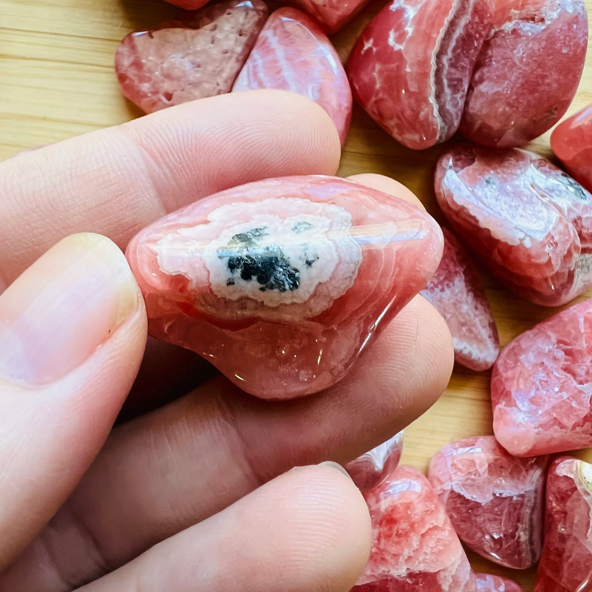 Whole-piece view of Rhodochrosite tumbled stone, from Catamarca Province, Argentina, captured in soft, even lighting.