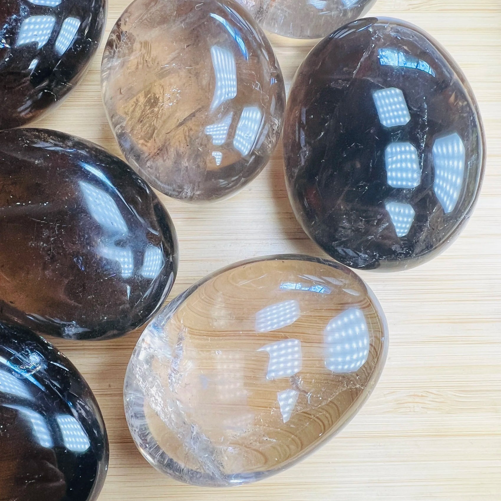 Bird's-eye view of Grade AA Smoky Quartz palm stone, often worked with for Grounding, sourced from Alaotra-Mangoro, Madagascar.