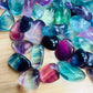 Looking down on Grade AAA Fluorite tumbled stone, often worked with for Focus, showing translucent edges.