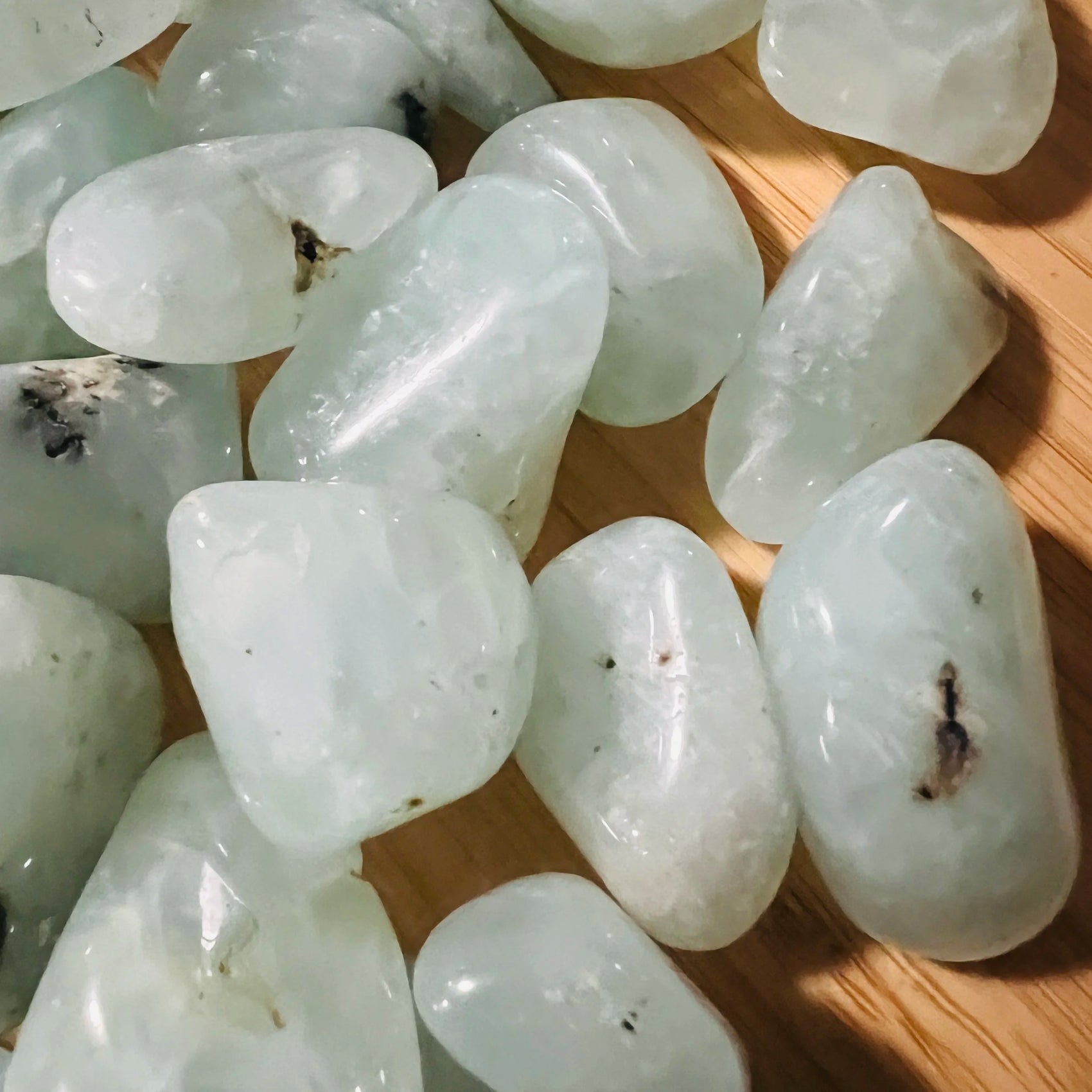 Opposite side of Prehnite tumbled stone, from Erongo, Namibia, showing natural sheen.