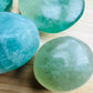 Side profile of Fluorite palm stone, Madagascar-sourced, traditionally used for Focus and Meditation.