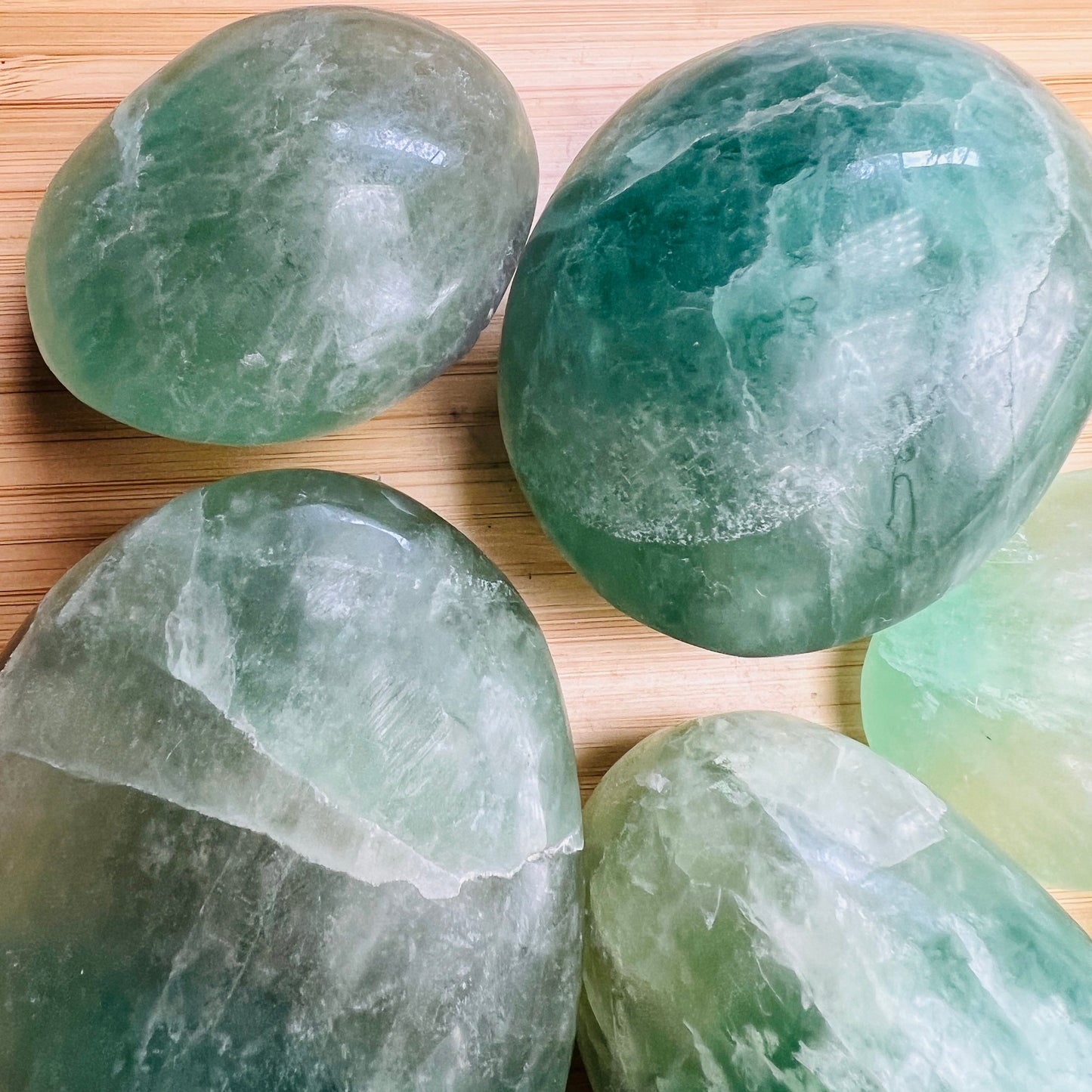 Top-side view of Fluorite palm stone, sourced from Amoron’i Mania, Madagascar, showing glassy finish.