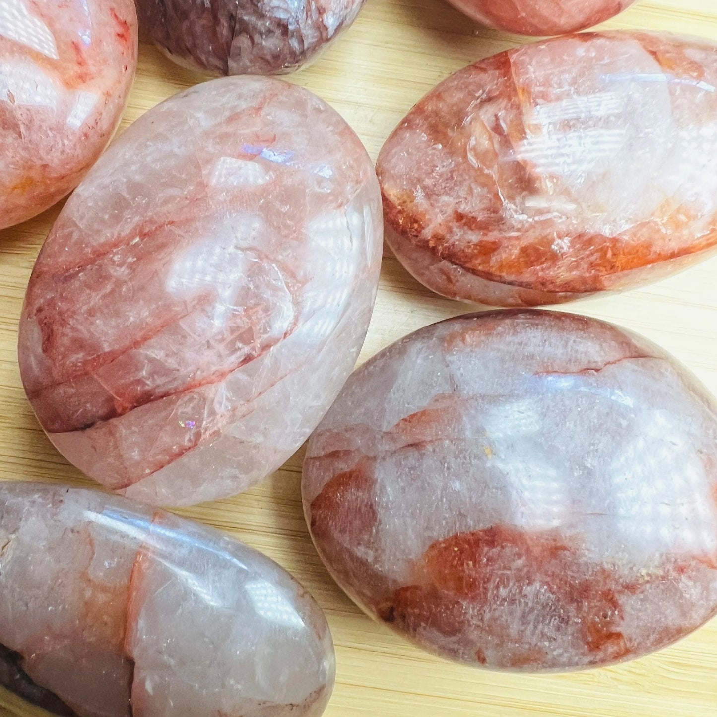 Back view of Grade AA Fire Quartz palm stone showing natural surface
