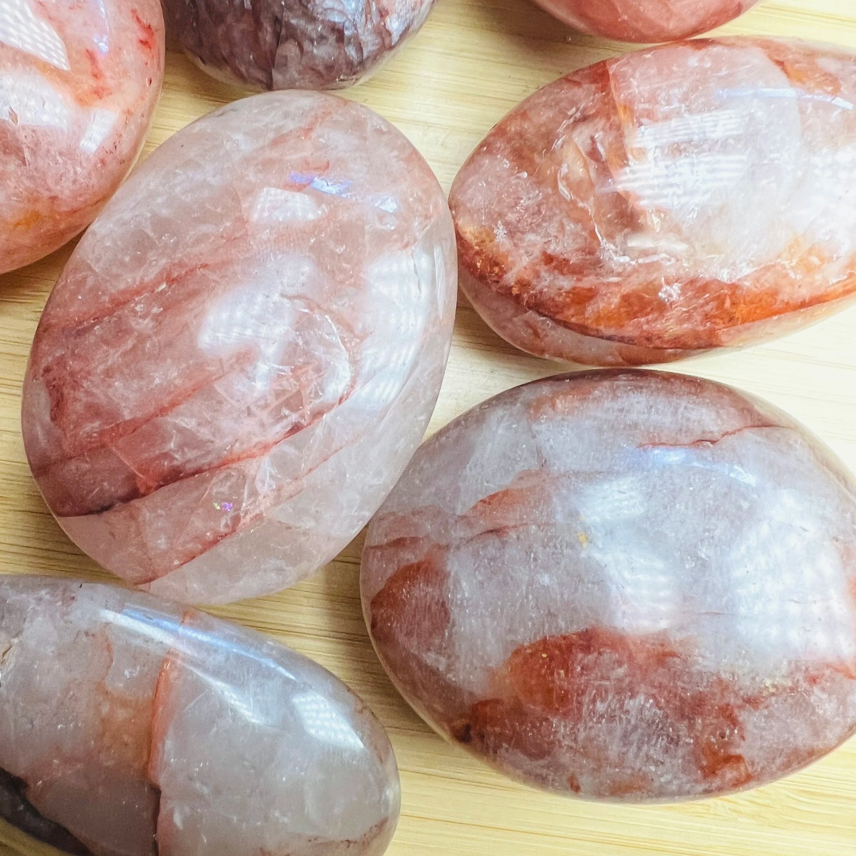 Back view of Grade AA Fire Quartz palm stone showing natural surface