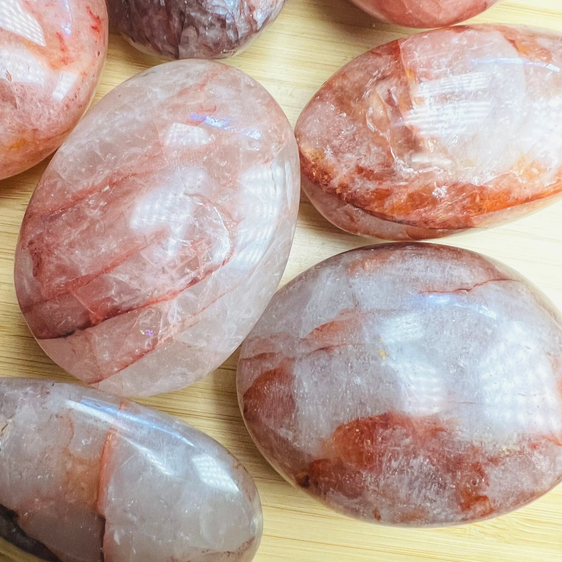 Back view of Grade AA Fire Quartz palm stone showing natural surface