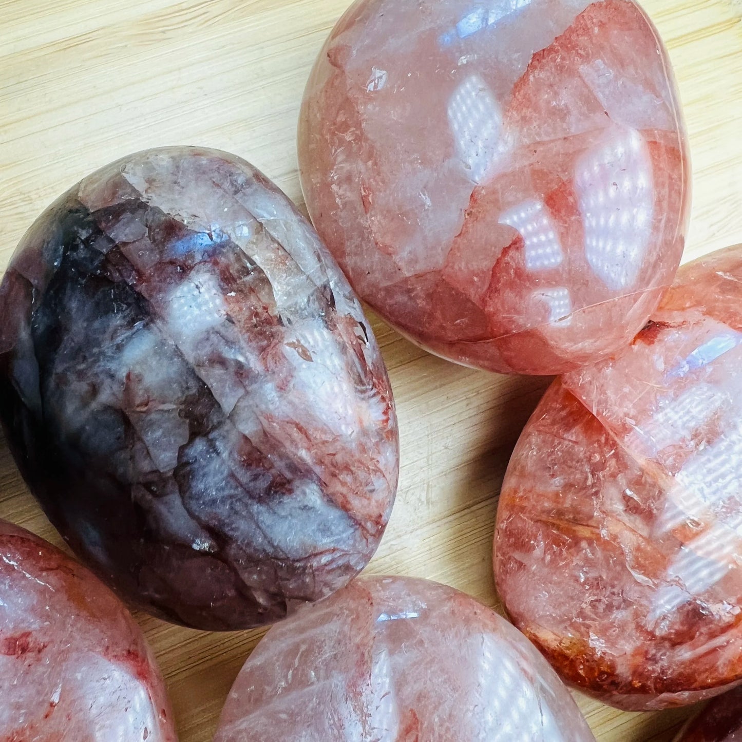 Detail shot of Grade AA Fire Quartz palm stone under natural light
