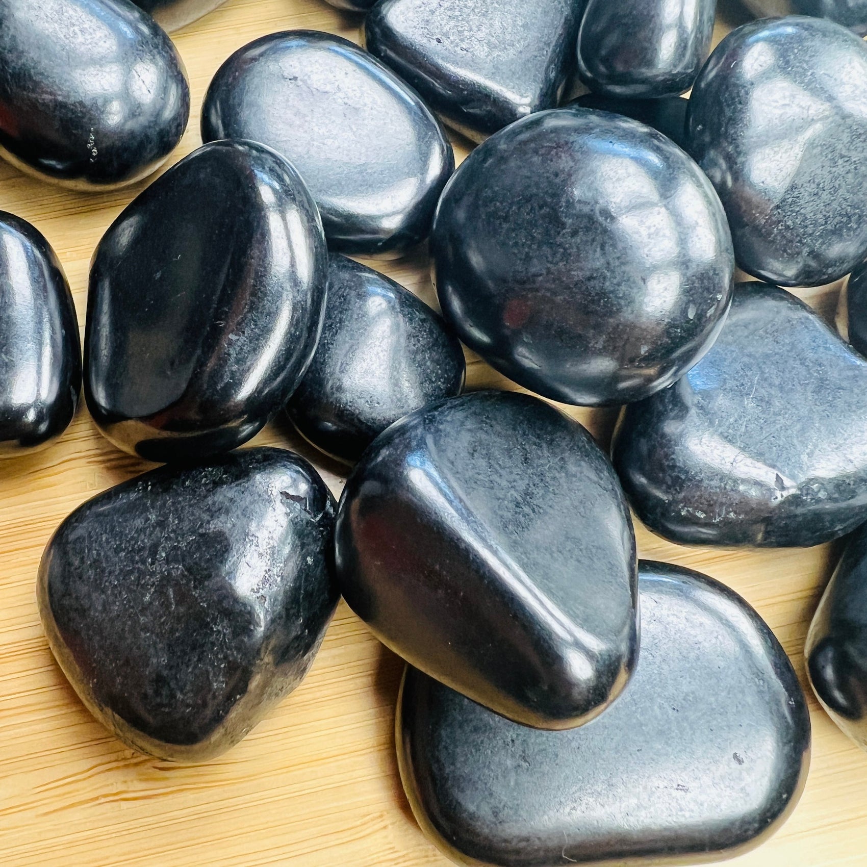 Natural surface of Shungite tumbled stone, showing natural texture.