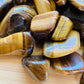 Full profile of Grade A Tiger Eye tumbled stone ready to ship from Beyond Bohemian