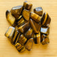Back view of Grade A Tiger Eye tumbled stone showing natural surface