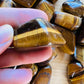 Full profile of Grade A Tiger Eye tumbled stone ready to ship from Beyond Bohemian