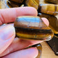 Full profile of Grade A Tiger Eye tumbled stone ready to ship from Beyond Bohemian