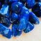 Reverse angle of Sodalite tumbled stone, from Kunene, Namibia, showing natural sheen.