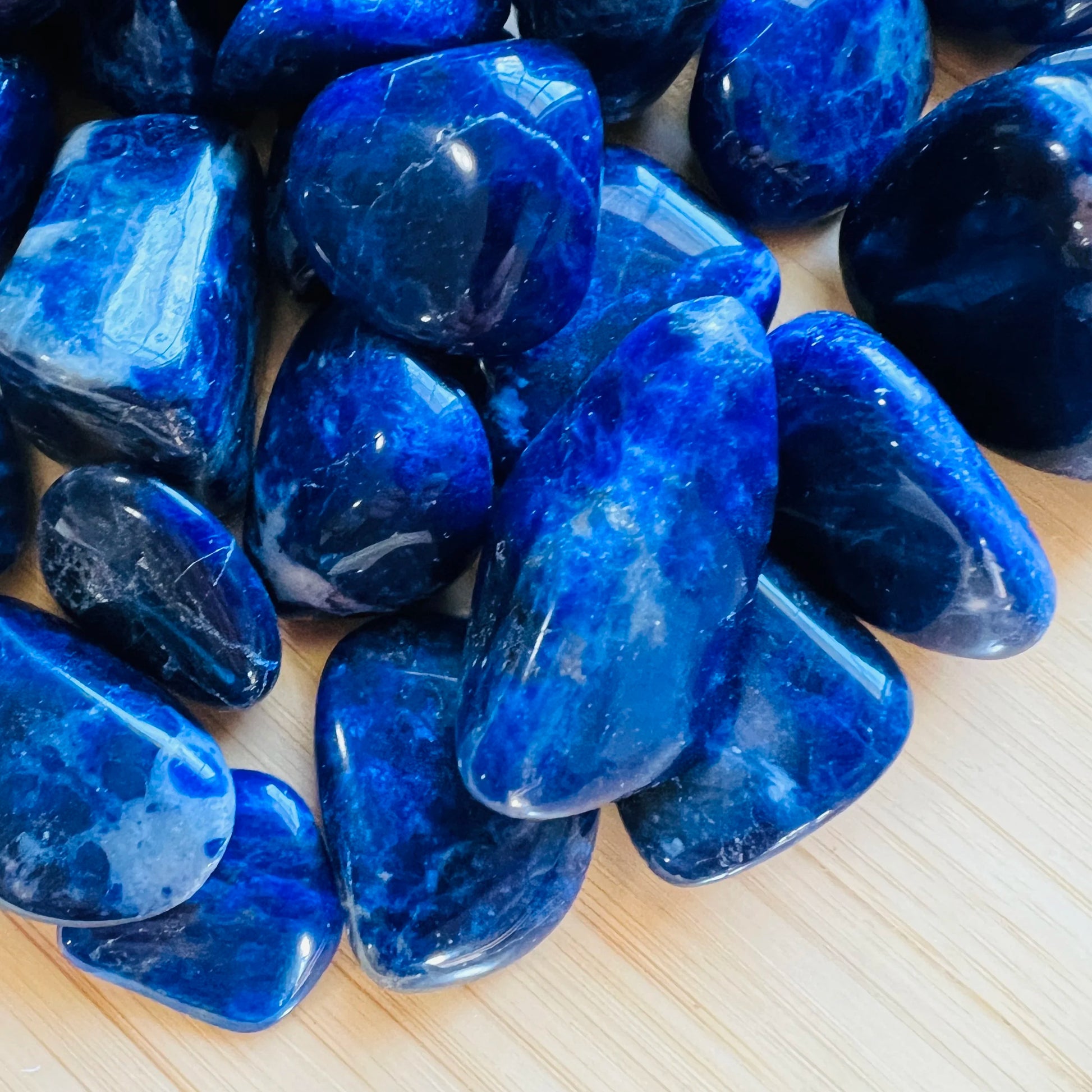 Reverse angle of Sodalite tumbled stone, from Kunene, Namibia, showing natural sheen.
