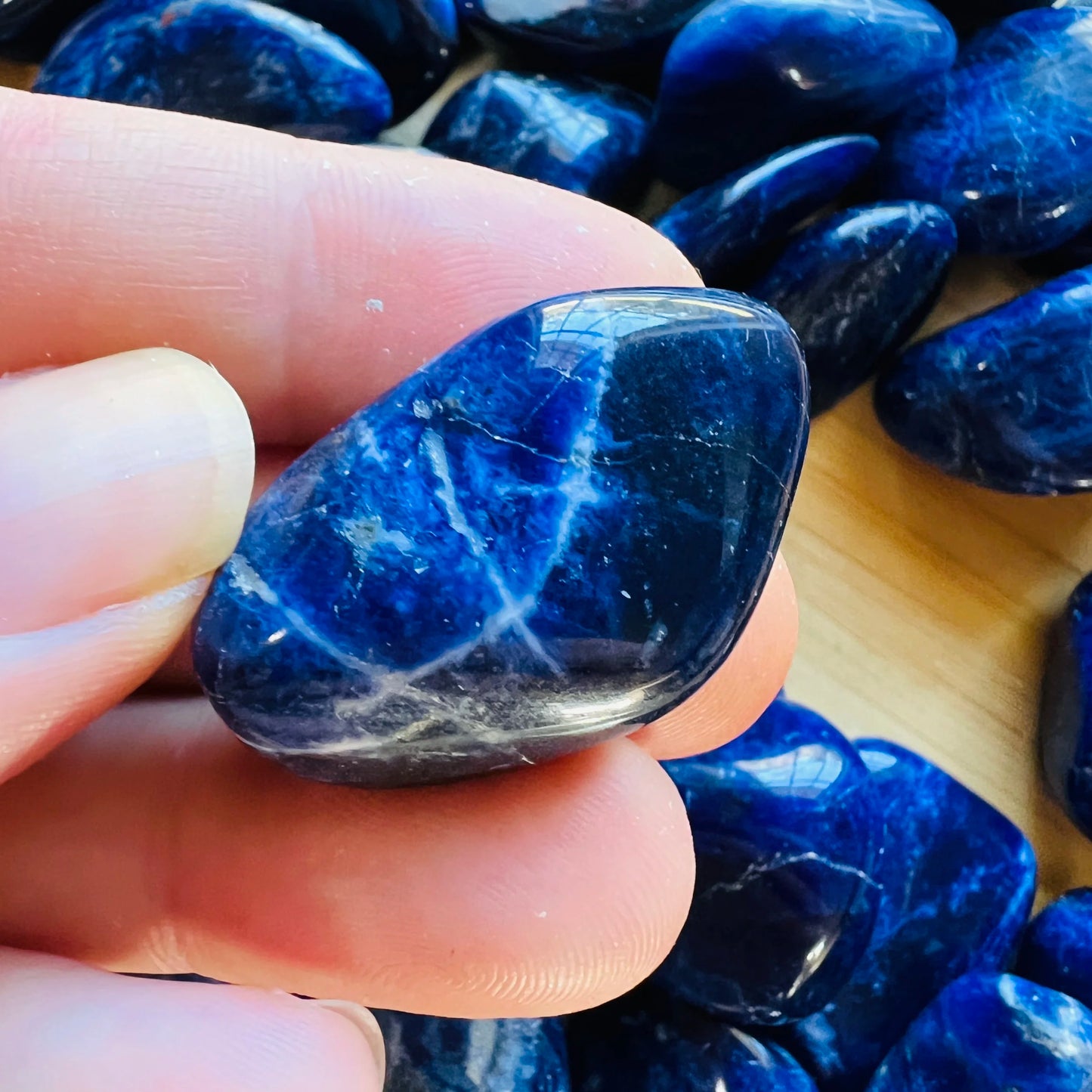 Back view of Grade AA Sodalite tumbled stone showing natural surface