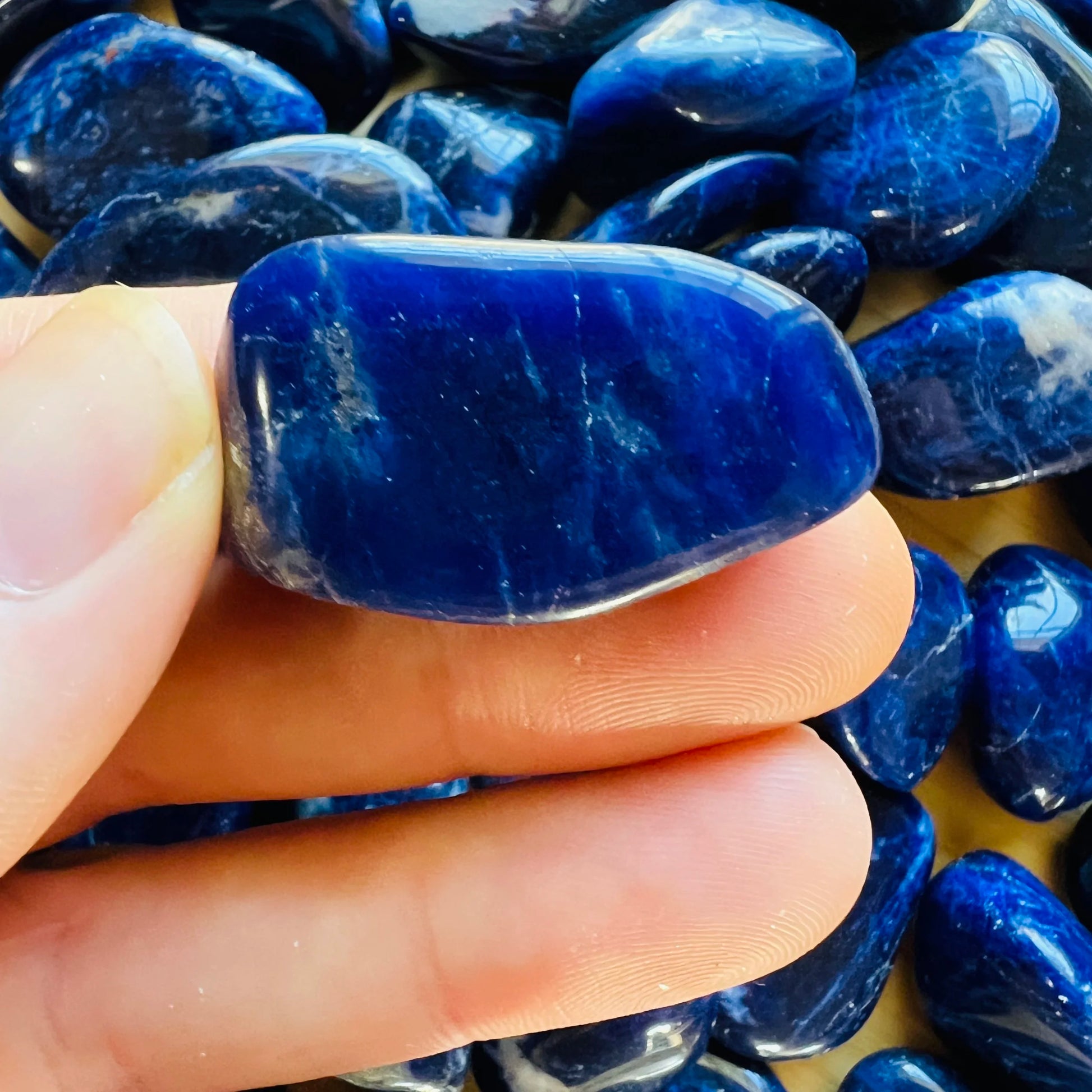 Whole-piece view of Sodalite tumbled stone, from Kunene, Namibia, traditionally used for Intuition, shown in its everyday setting.