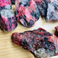 Detail shot of Grade AA Rhodonite raw under natural light