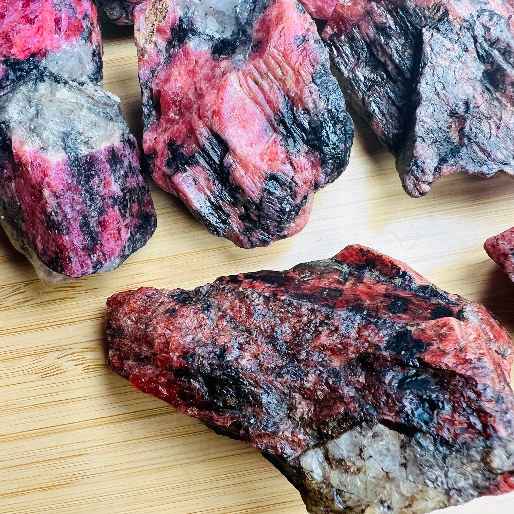 Detail shot of Grade AA Rhodonite raw under natural light