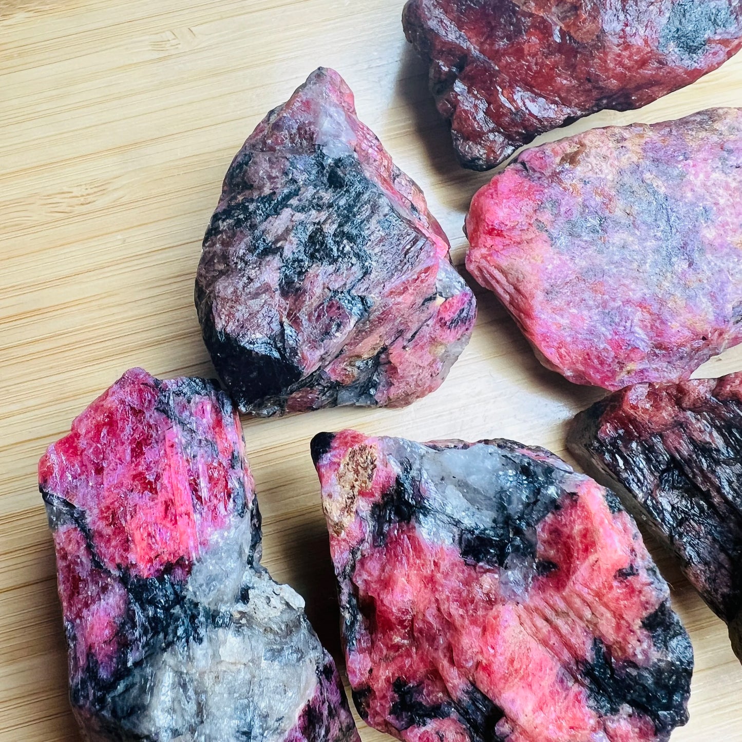 Full profile of Grade AA Rhodonite raw ready to ship from Beyond Bohemian