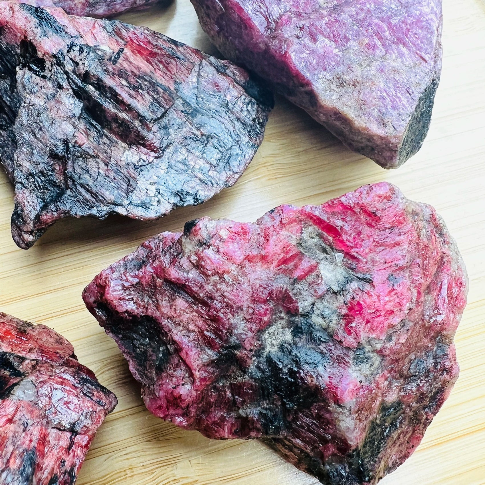 Close-up of Rhodonite raw stone from Zimbabwe, soothing wellness stone for Emotional Healing