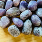Magnified detail of Lepidolite tumbled stone, showing glassy finish, linked to Stress Relief.