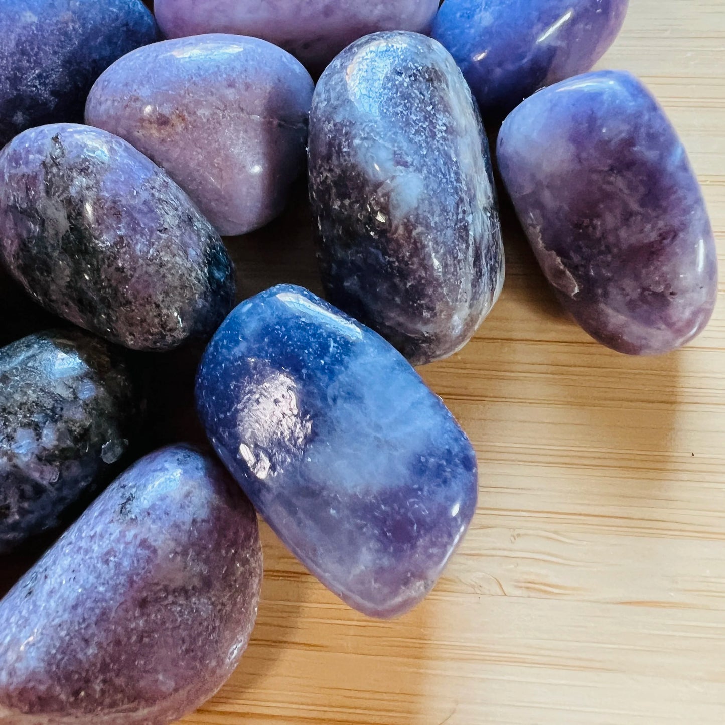 Top view of Lepidolite tumbled stone, showing natural variation, Namibia-sourced.