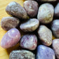Side angle of Grade A Lepidolite tumbled stone, showing natural texture.