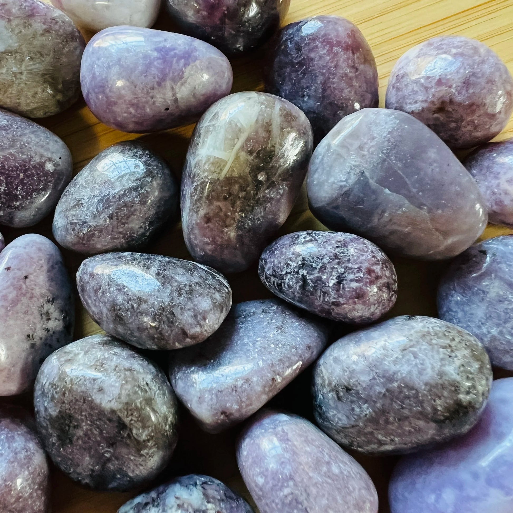 Alternate side of Lepidolite tumbled stone, showing natural variation, traditionally used for Stress Relief and Emotional Healing.