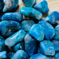 Back view of Chrysocolla tumbled stone, showing characteristic color.