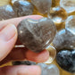 Texture-level view of Smoky Quartz polished heart, drawn on for Grounding, from Madagascar.