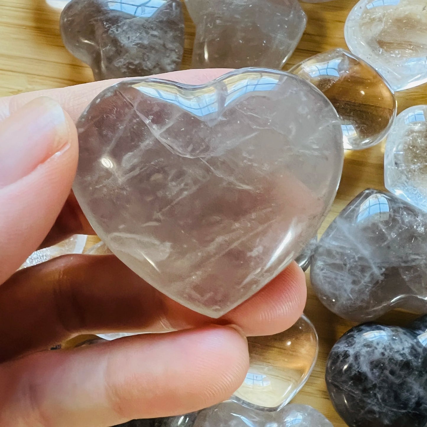 Lateral view of Smoky Quartz polished heart, sourced from Vakinankaratra, Madagascar, traditionally used for Grounding.