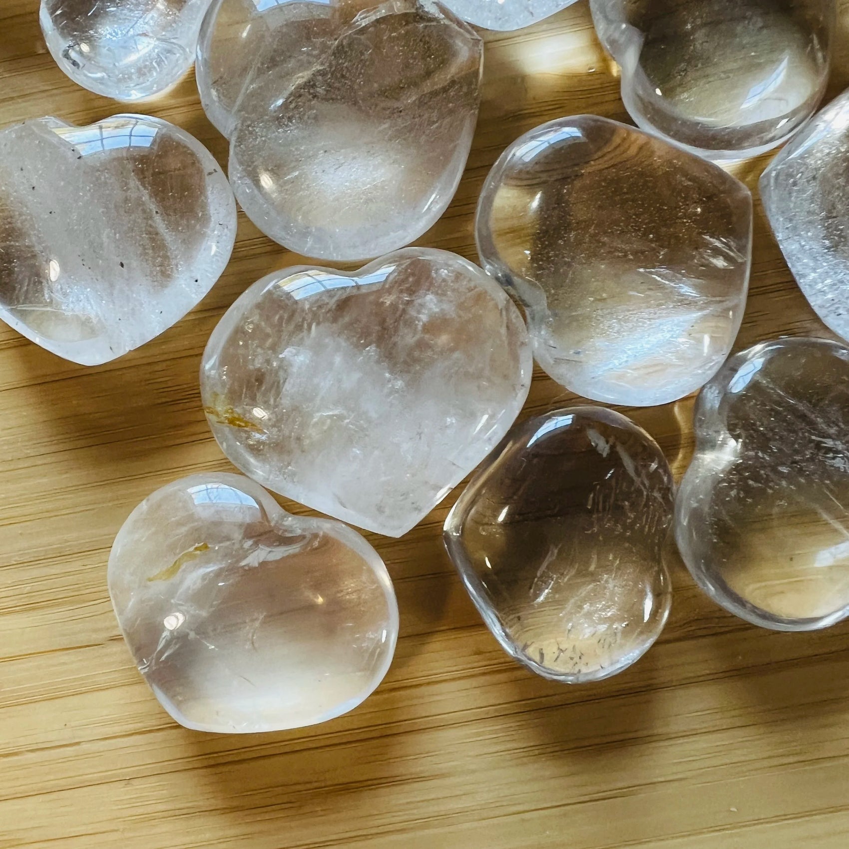 Side-on view of Grade AA Clear Quartz polished heart, often paired with practices around Cleansing and Meditation, showing.