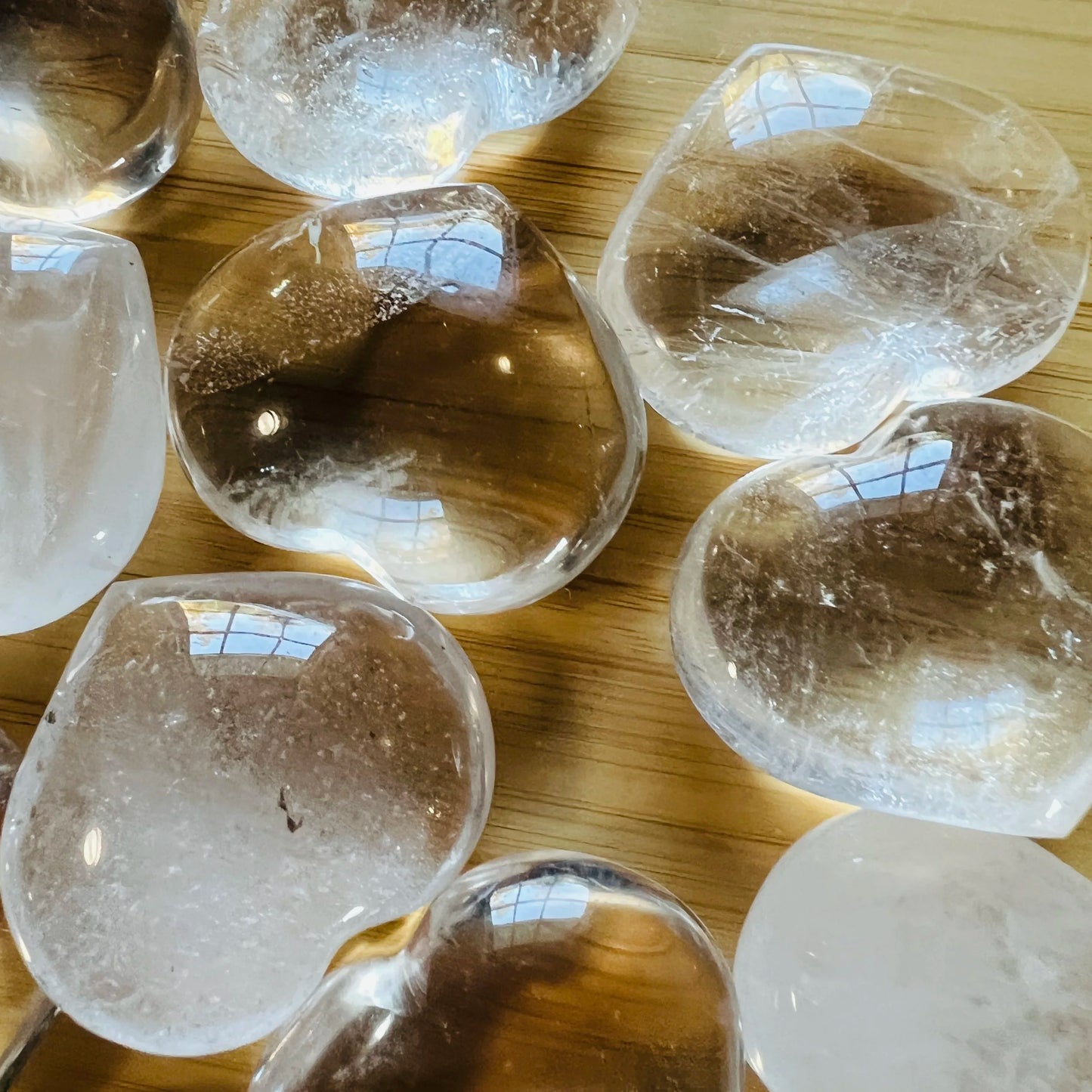 Detail of Grade AA Clear Quartz polished heart, sourced from Madagascar, showing natural inclusions.