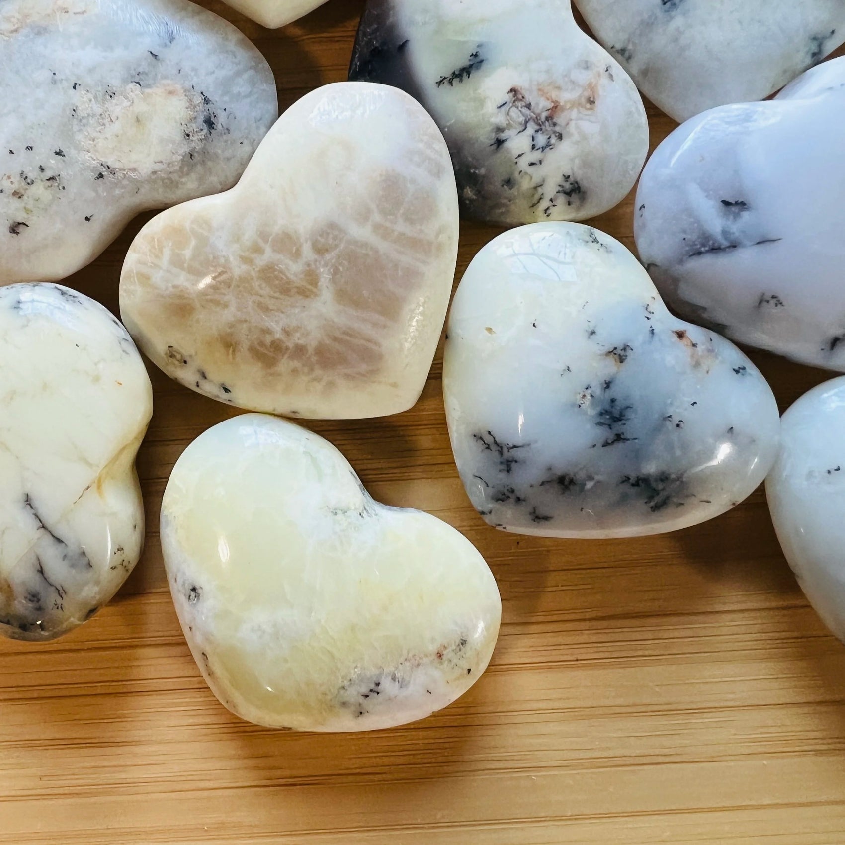Close-up of Dendritic Opal heart carving from Madagascar, soothing wellness stone for Healing