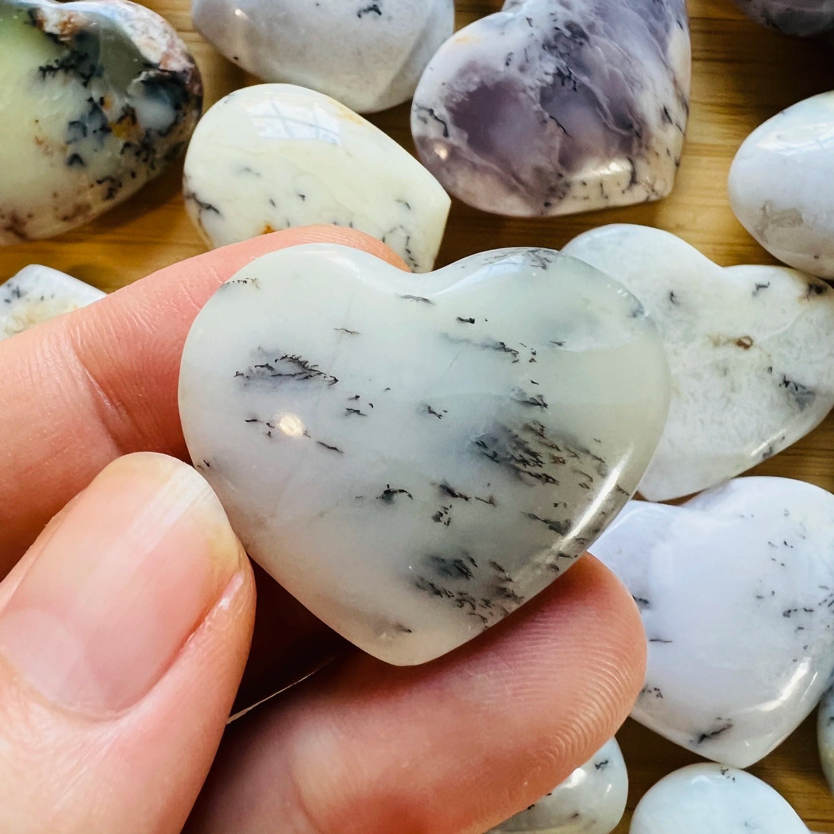 Close-up of Dendritic Opal heart carving from Madagascar, soothing wellness stone for Healing