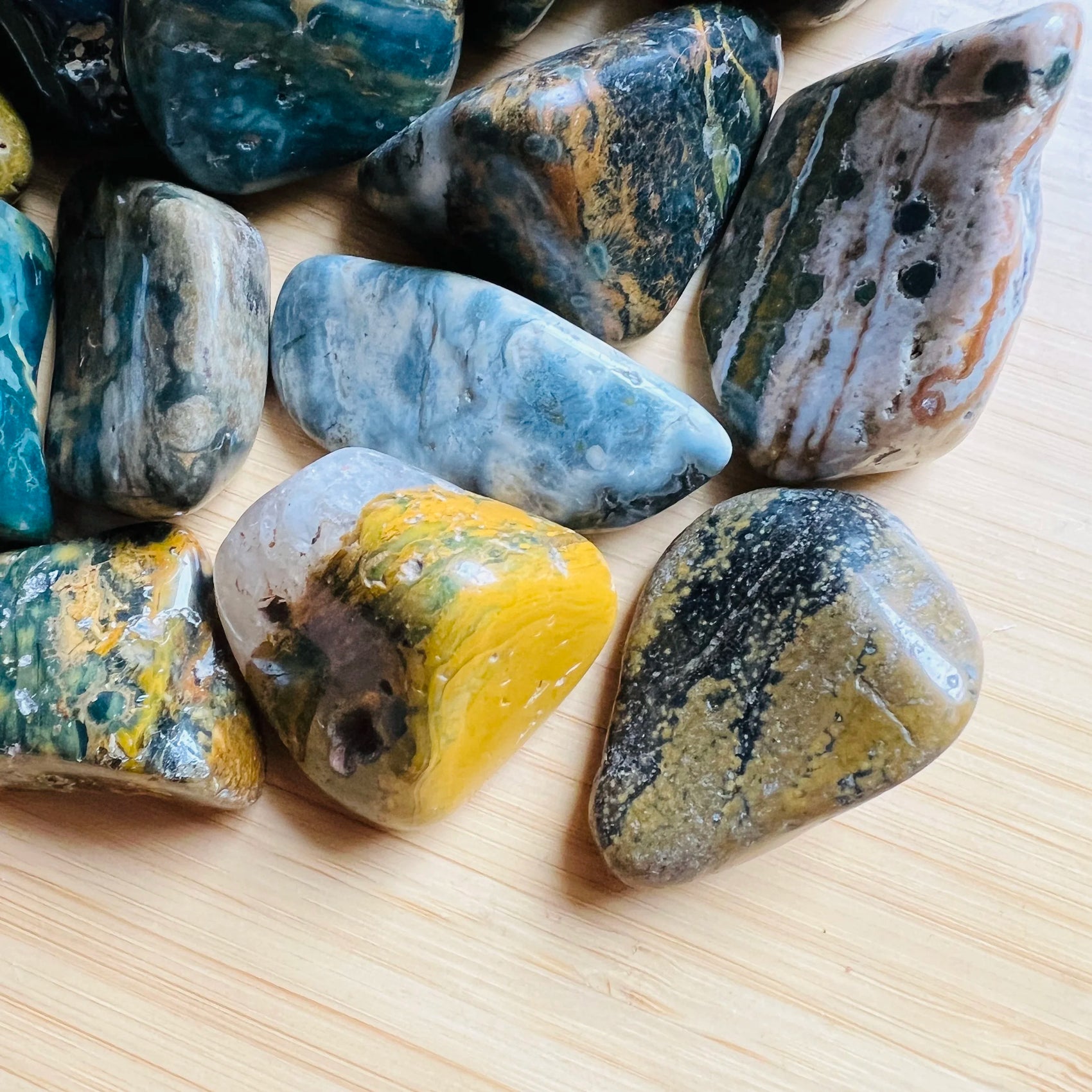 Top angle of Ocean Jasper tumbled stone, showing characteristic color.