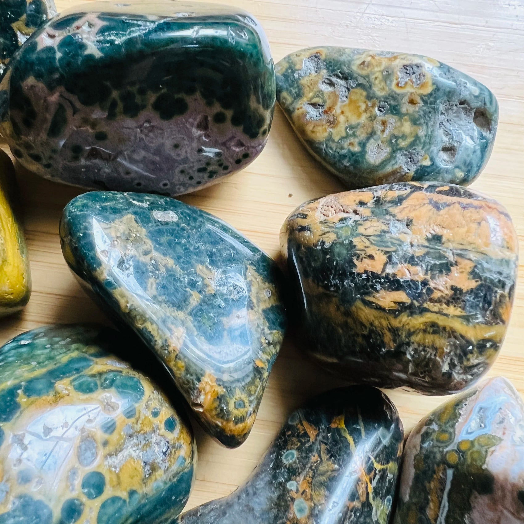 Scale reference of one Ocean Jasper tumbled stone for scale, sourced from Sofia, Madagascar.
