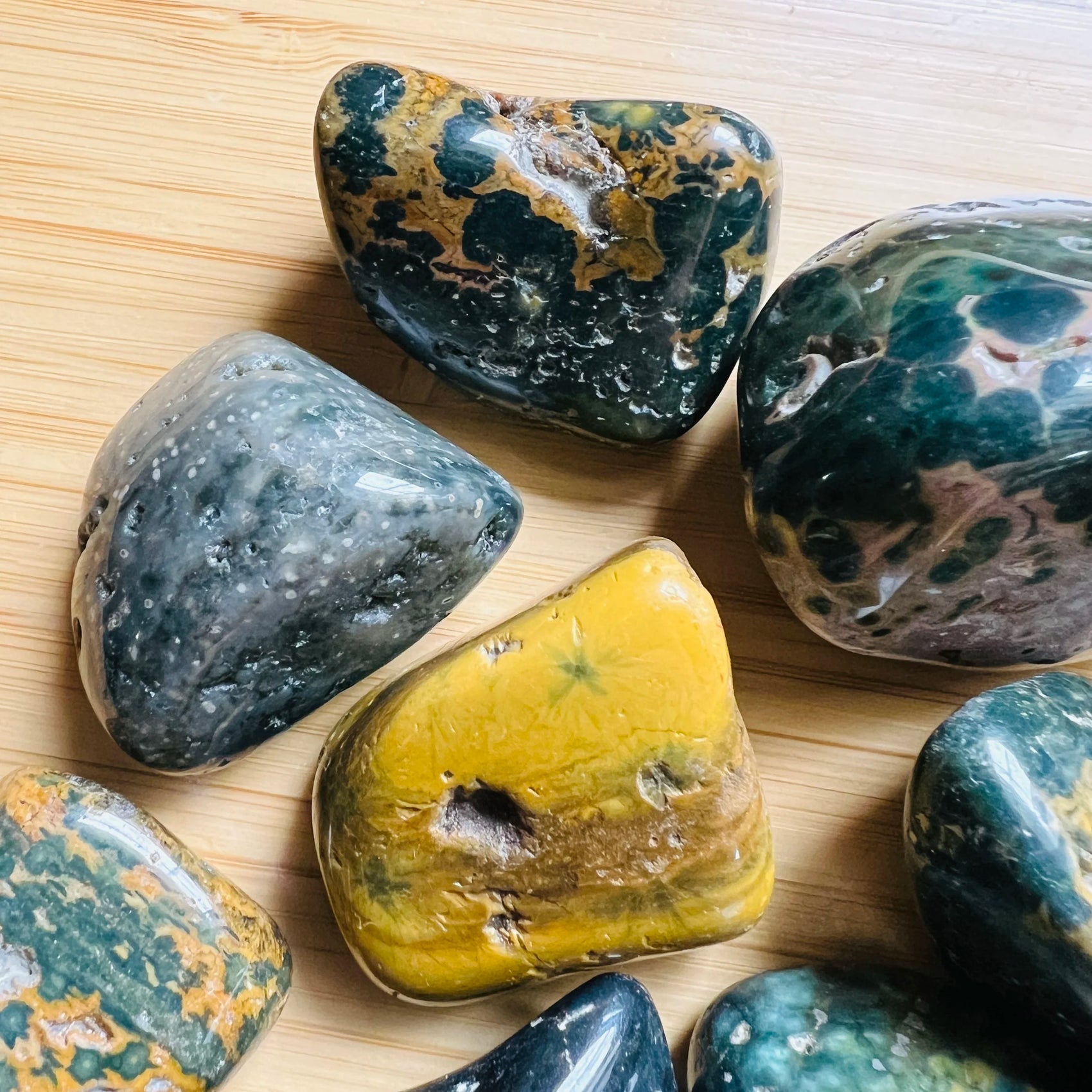 Lateral view of Ocean Jasper tumbled stone, showing natural sheen.