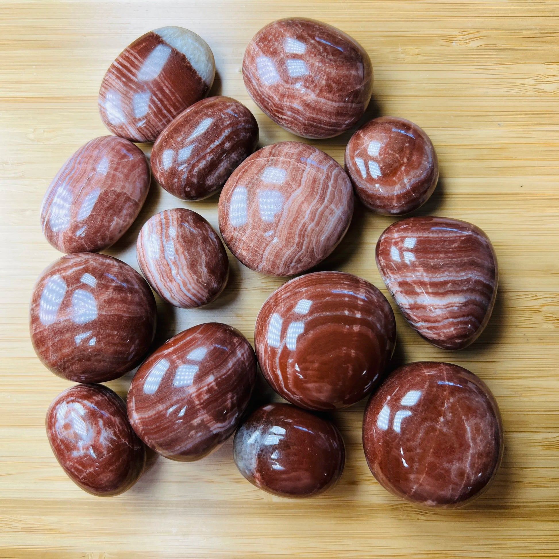 Full profile of Grade AAA Red Aragonite tumbled stone ready to ship from Beyond Bohemian