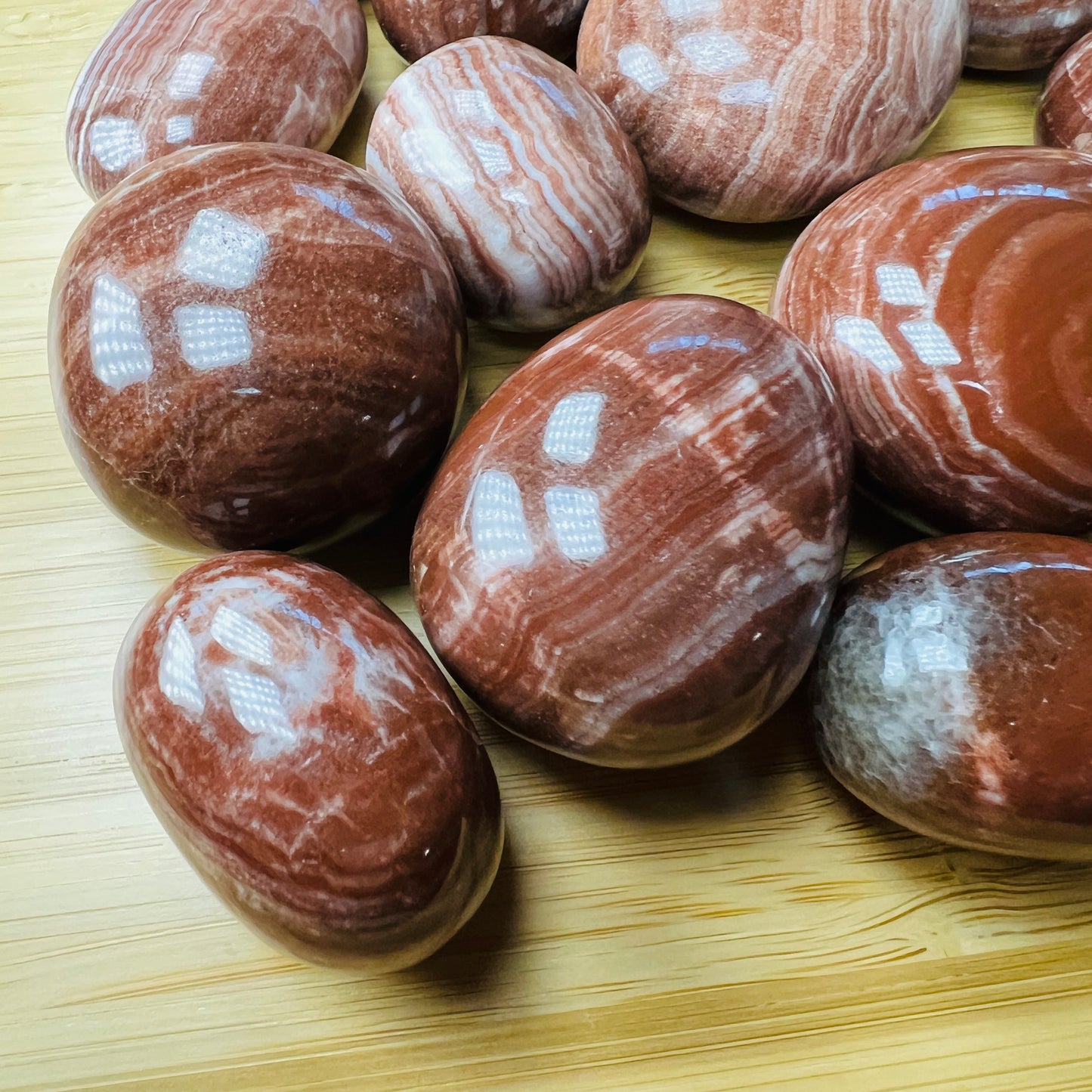 Full profile of Grade AAA Red Aragonite tumbled stone ready to ship from Beyond Bohemian