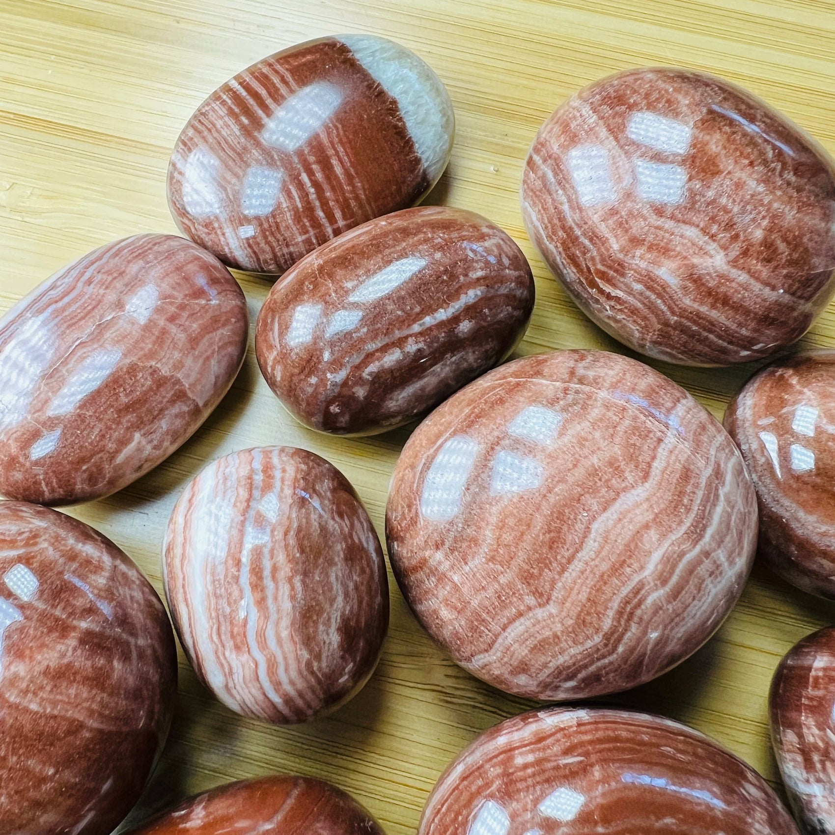Full profile of Grade AAA Red Aragonite tumbled stone ready to ship from Beyond Bohemian