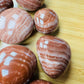 Full profile of Grade AAA Red Aragonite tumbled stone ready to ship from Beyond Bohemian