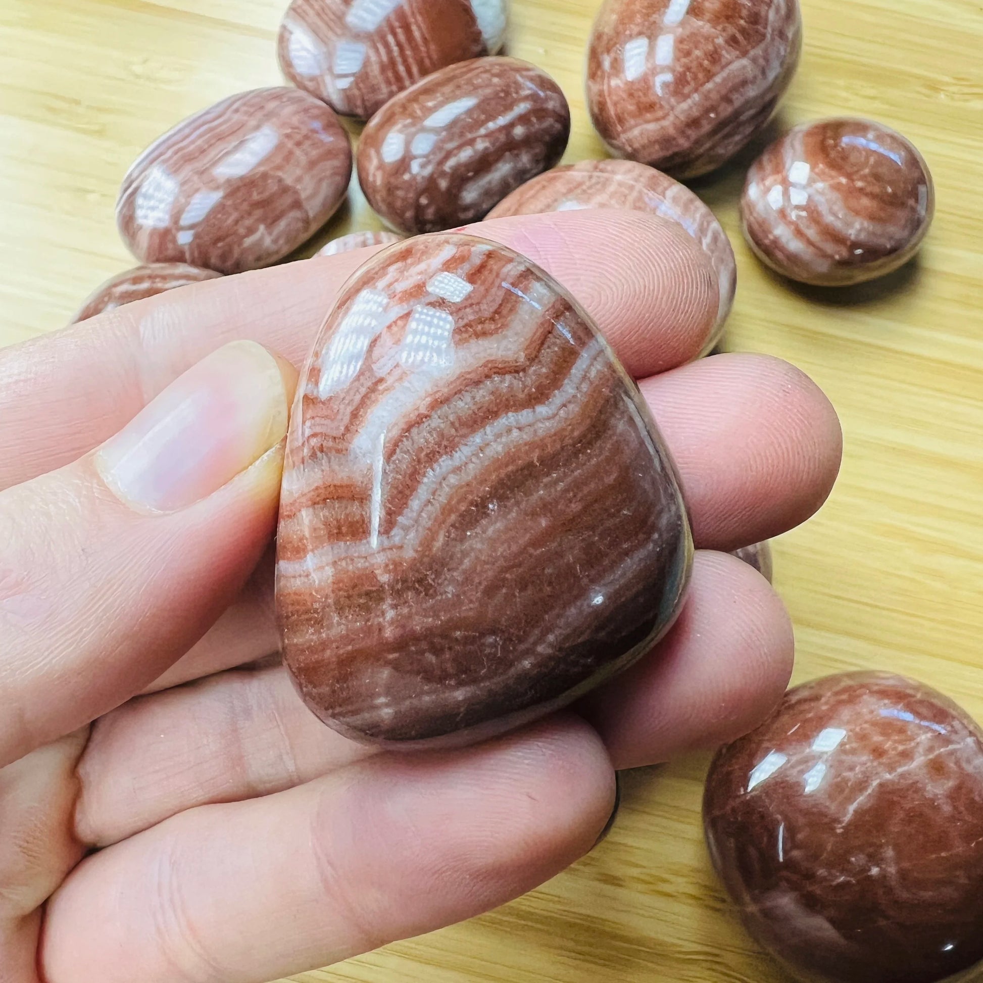 Full profile of Grade AAA Red Aragonite tumbled stone ready to ship from Beyond Bohemian